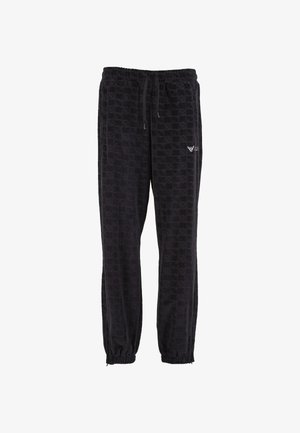 Pantaloni jogger in velluto nero con cintura elastica, stringa, polsini alle caviglie e motivo a scacchi sottile con piccolo logo sulla coscia sinistra.