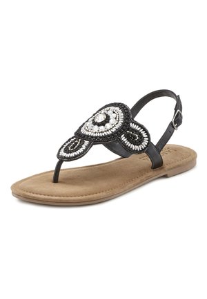 Black beaded thong sandal with a circular embellishment, featuring a cushioned tan footbed and adjustable strap. Textured surface detailing.