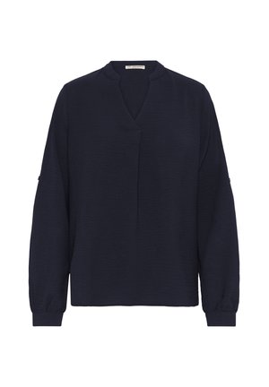 Granatowa bluzka z długim rękawem, z dekoltem w kształcie litery V i luźnym krojem. Teksturowana tkanina, elastyczne mankiety oraz subtelny środkowy szew.