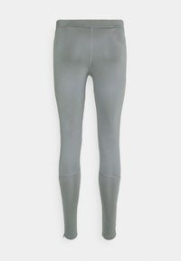 Leggings gris avec une texture lisse, dotés d'une taille haute et de deux poches latérales, se rétrécissant jusqu'à des zips aux chevilles pour un design ajusté.