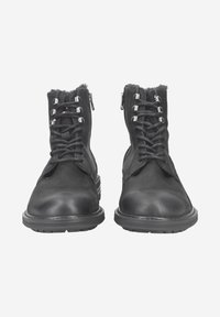 Bottines en cuir noir avec un laçage à l'avant et des zips sur les côtés, dotées d'œillets métalliques et de semelles texturées pour une meilleure adhérence.