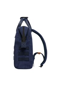 Navy corduroy backpack with contrasting black zipper, three horizontal webbing straps on the side, and a leather accent on the shoulder strap.