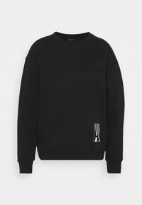 Felpa nera in cotone con maniche lunghe, polsini a costine e collo tondo, caratterizzata da un logo bianco sul lato inferiore sinistro.