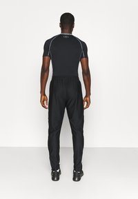 Under Armour Pantalones deportivos - black