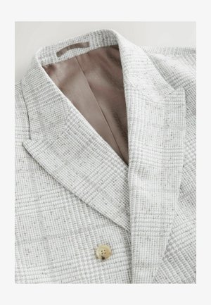 Hele halli tekstuuriga bleiser, millel on nurgeline krae, ühe nupuga kinnitamine ja sile beež sisevooder.