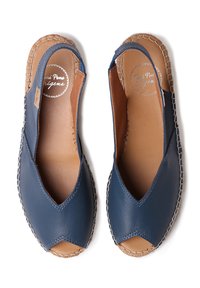 Navy blue leather espadrilles with open toes, features a stitched tan sole, and elastic side cutouts for a secure fit.