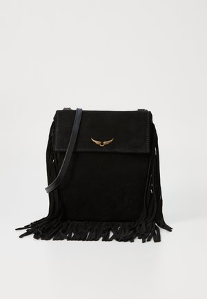 Black suede crossbody bag with fringe detail, a gold-toned wing logo on the flap, and a detachable strap. Compact and structured design.