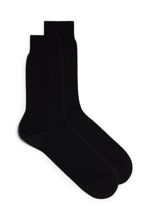 Schwarze Crew-Socken aus glattem, dehnbarem Stoff mit gerippten Bündchen und verstärktem Fersen- und Zehenbereich für Langlebigkeit.