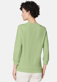 Lichtgroene pullover sweatshirt met driekwartmouwen, ronde halslijn en geribbelde manchetten. Soepele katoenmix stof, casual pasvorm.