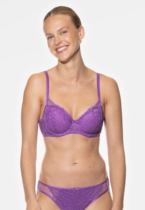 Purple lace bra with thin straps and scalloped edges, featuring a smooth shape and a small bow detail at the center. Matching purple underwear.