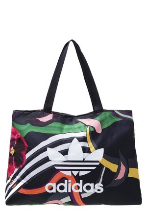 Stor Adidas mulepose med sorte hanke, farverigt abstrakt blomstermønster og fedt hvidt Adidas-logo med trefoldssymbol på forsiden.