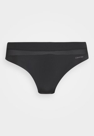 Svart bikiniunderdel laget av et glatt, elastisk stoff. Den har en flat midjebånd med mesh-detaljer og en liten logo på siden.