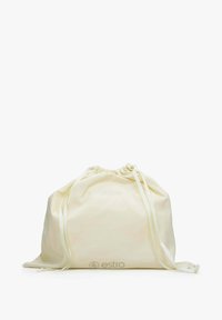 Drawstring bag in soft, cream fabric. Rounded shape with gathered top and two long satin straps. Features a subtle logo at the base.