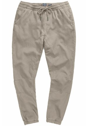 Pantalones jogger beige con cintura elástica, cierre con cordón, bolsillos laterales y tobillos ajustados. Fabricados con un tejido suave y transpirable.