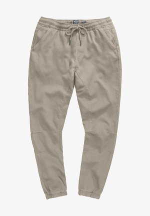 Beige joggerbroeken met een elastische tailleband, trekkoordsluiting, zijzakken en taps toelopende enkels. Gemaakt van zachte, ademende stof.