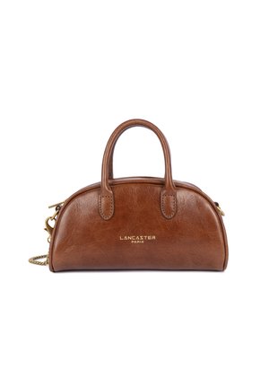 Brown leather handbag with rounded shape, dual short handles, and gold logo. Features a detachable chain strap and a zip closure.
