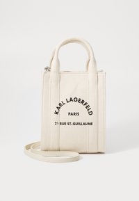 Borsa in tela off-white con doppio manico superiore e tracolla removibile, caratterizzata da testo stampato in nero. Forma rettangolare.