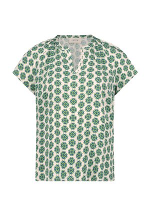 Valkoinen lyhythihainen pusero, jossa on sinivihreä kukkakuvio ja pieni V-kaula-aukko kauluksessa.