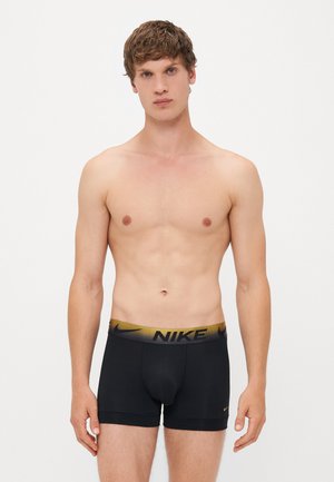Zwarte boxershorts met een gouden Nike-logo op de tailleband. De stof is glad, elastisch en past comfortabel.