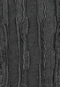 Black textured fabric featuring varying vertical lines and stitched patterns. Material resembles denim with a smooth, soft finish.