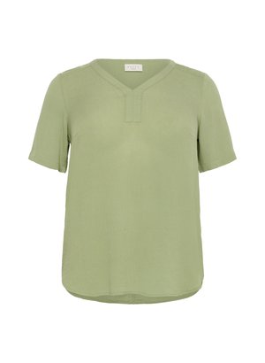 Top a maniche corte di colore verde chiaro, con scollo a V e vestibilità rilassata. Realizzato in un tessuto testurizzato con dettaglio dell'orlo arrotondato.