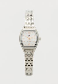 Silver metal watch with a square case, white textured dial displaying Roman numerals, and a link bracelet. Features a logo.