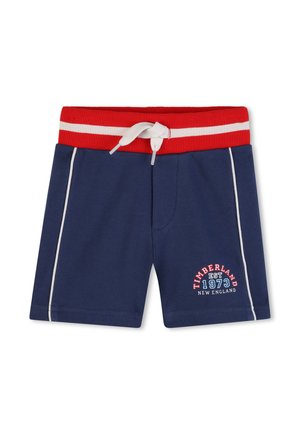 Pantaloncini blu navy per bambini piccoli, con elastico rosso in vita, cordoncino bianco, strisce laterali bianche e logo Timberland 1973 New England sulla gamba.