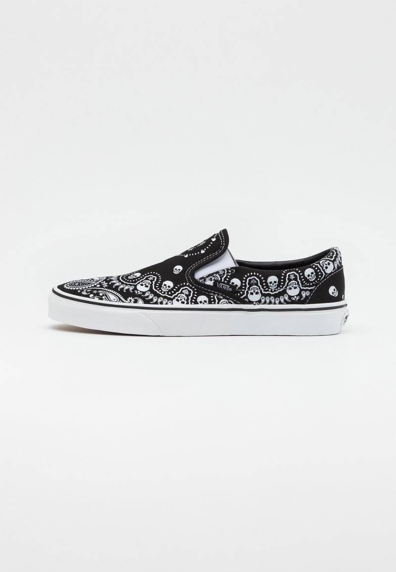 Black slip-on sneaker with white skull and swirl pattern. Canvas upper, rubber sole, and padded collar. Features stitching accents.