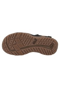 Suela de zapato de goma marrón con un patrón de relieve texturizado, que presenta surcos y crestas para mayor tracción. Duradera y diseñada para su uso al aire libre.