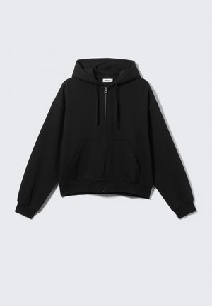 Black cropped hoodie with a zippered front, drawstring hood, and side pockets. Made from soft fabric with ribbed cuffs and hem.