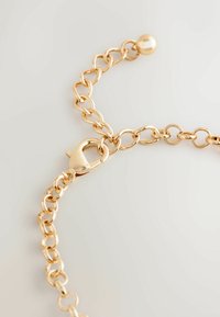 Gold metal chain bracelet featuring oval links, a lobster clasp, and a spherical accent at the end. Smooth, reflective texture.