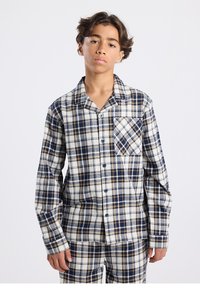 Plaid pajama set in beige, navy, and cream tones. Long-sleeved shirt with a pocket; button front. Soft, woven fabric with check pattern.