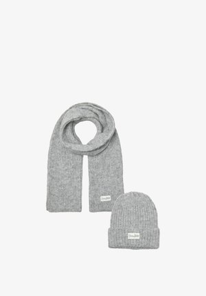 Grijze gebreide sjaal en muts set, met een geribbelde textuur en geweven merklabel op beide stukken. Zacht wolmateriaal.