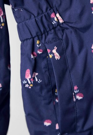 Jūras spēku audums ar jaucīgu rozā trušu, sarkano sēņu un krāsaino ziedu zīmējumu. Vāka detaļa jostas apvidū, lai nodrošinātu labu piegulšanu.