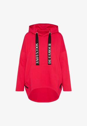 Red hoodie made of cotton, featuring a front pocket, black drawstrings with white text, and a curved hemline.
