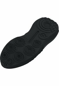 Black rubber sneaker sole featuring a textured design with circular patterns and ridges for traction. Marked with "Under Armour" logo.