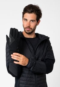 Gants thermiques noirs avec des motifs de préhension texturés, dotés d'une doublure intérieure douce et d'une sangle de poignet réglable. Conçus pour la chaleur et le confort.