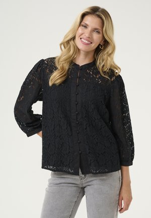 Black lace blouse with floral pattern, long puff sleeves, and button front design. Features a solid black inner layer and textured accents.