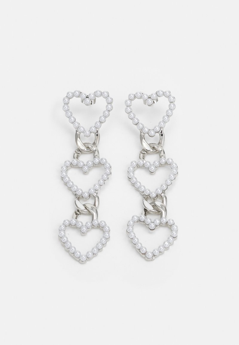 White heart-shaped earrings made of beads, linked by silver hardware, featuring three layered heart designs.