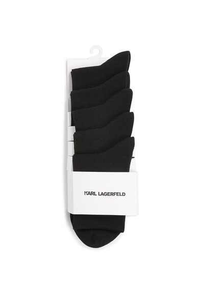 Chaussettes en coton noir vendues par lot de cinq, avec une texture lisse et des bords élastiques. Présentées sur un fond blanc avec une étiquette de marque.