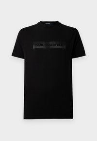 Svart t-skjorte laget av bomull med rund hals; har et matt svart rektangulært logobånd med teksten "KARL LAGERFELD" over brystet.