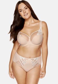 Nude koronkowy stanik i majtki o wysokim stanie, z przezroczystymi panelami, kwiatowymi akcentami koronkowymi oraz miękkim, gładkim materiałem. Subtelny detal w postaci kokardki na majtkach.