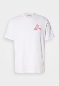 White cotton t-shirt with a crew neck and short sleeves. Features a red graphic pattern of "CK" on the left chest area.