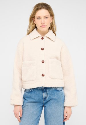 Cream-colored, fuzzy jacket with a collar, button closure, and two front pockets. Features brown buttons and a cropped design.