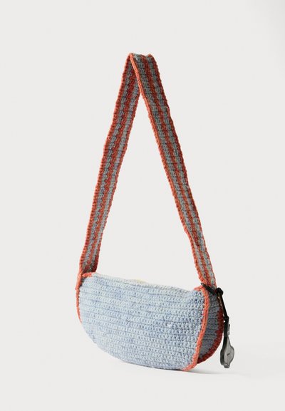 Zils un oranžs tamborēts soma ar apaļu formu, teksturētu virsmu un svītrainu siksnu. Iekļauta melna rāvējslēdzēja detaļa.