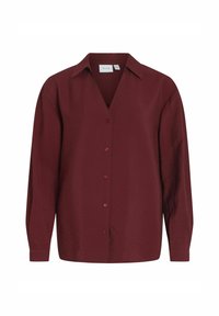 Blusa burdeos de manga larga con un cuello clásico, botones en la parte delantera y una tela suave y texturizada. Diseño de cuello en V con un detalle mínimo.