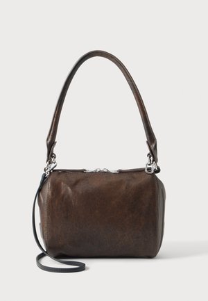 Borsa in pelle marrone scuro con bordi arrotondati, manico corto singolo, tracolla sottile nera staccabile e chiusura con cerniera superiore su sfondo bianco.