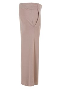 Pantalones beige de corte holgado con cintura elástica y bolsillo lateral, mostrados de lado sobre un fondo blanco.