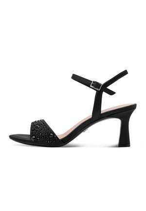 Schwarze offene High Heel Sandale mit Knöchelriemen und dekorativen schwarzen Perlen am Zehenriemen, in Seitenansicht vor weißem Hintergrund.