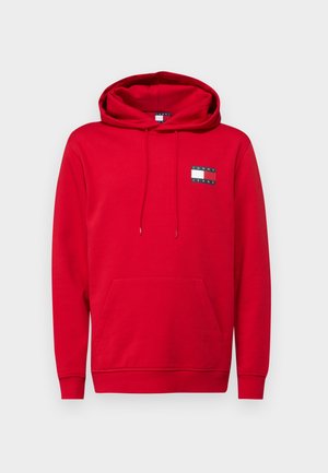 Red hoodie in cotton blend fabric, featuring a kangaroo pocket, drawstring hood, and a logo patch on the upper left side.